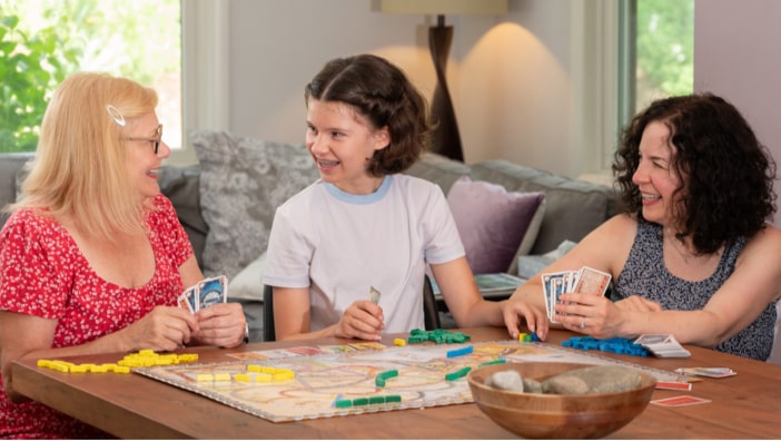Kathy and Diane playing a game with their daughter