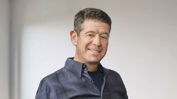 Man smiling standing in room.