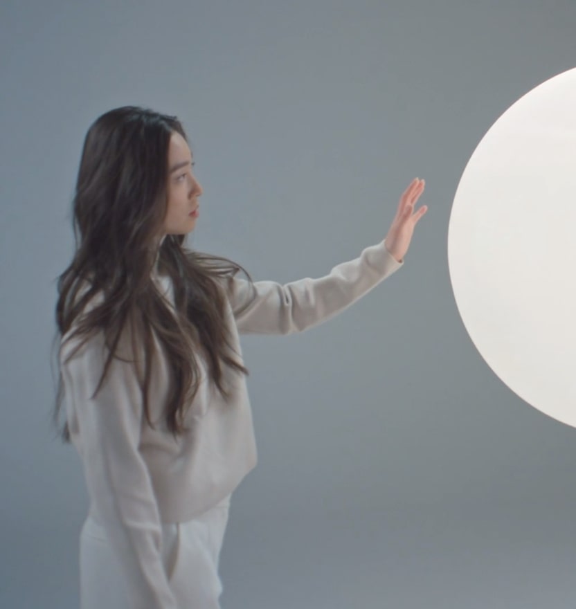 Woman touching light orb