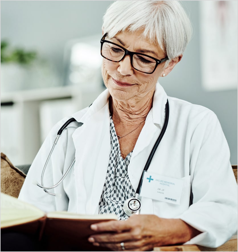 doctor with stethoscope reading book