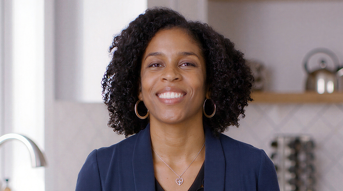 Black woman with curly hair smiling