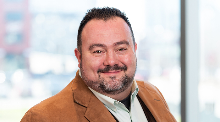 Hispanic American man with short haircut smiling