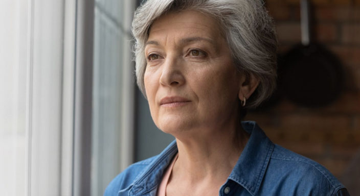 Older woman looking out the window