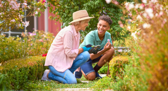 A grandmother gardening with her grandson