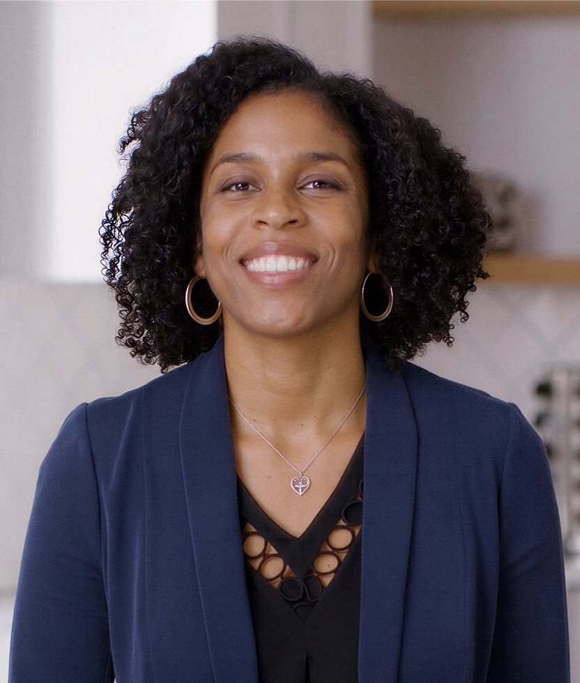 Black woman with curly hair smiling