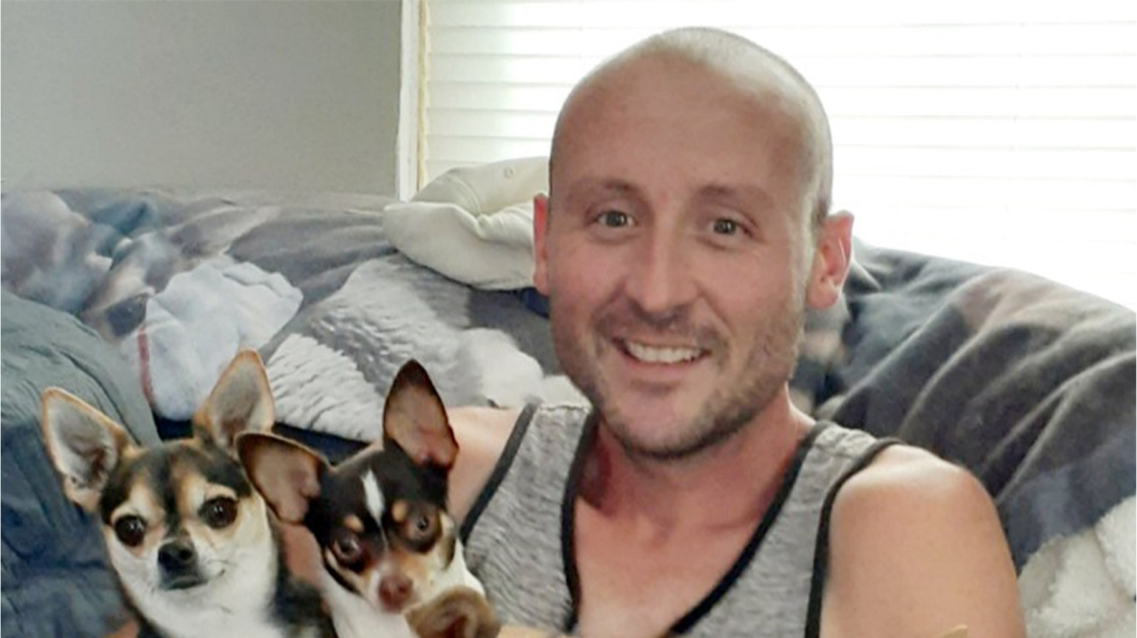 Bryan holding his two dogs