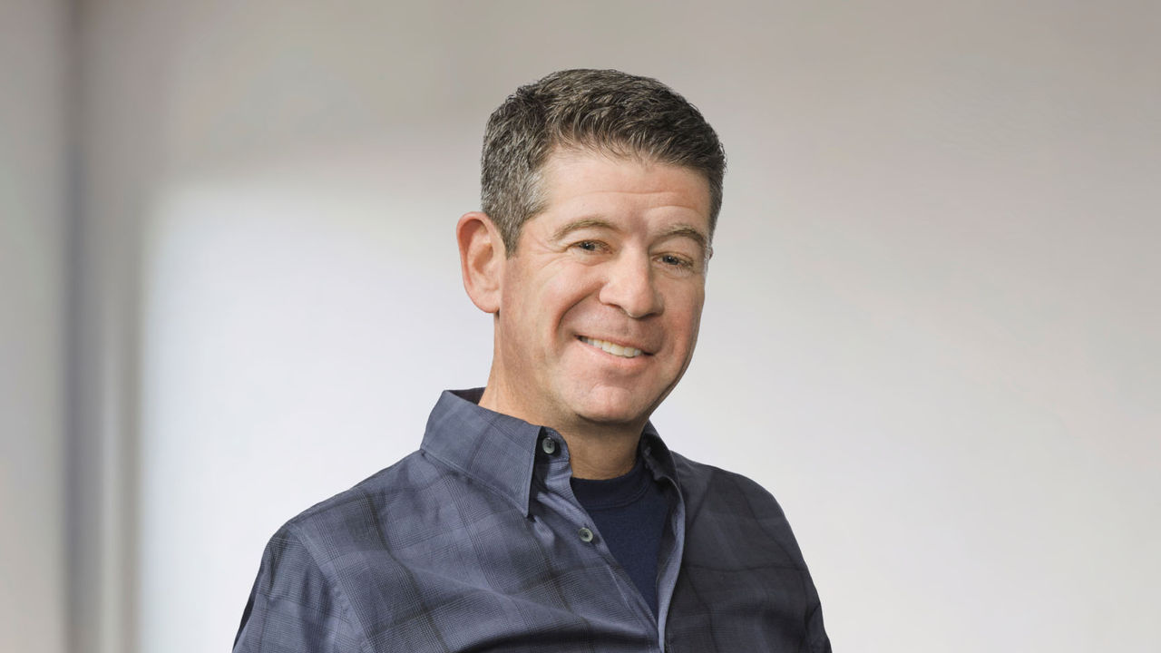 Man smiling standing in room.