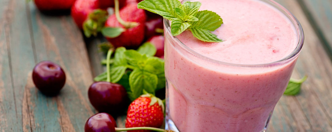Pink smoothie next to fruit