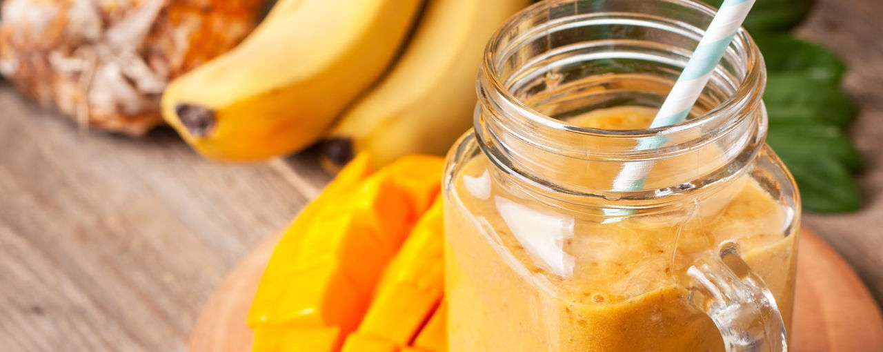 Orange smoothie next to fruit
