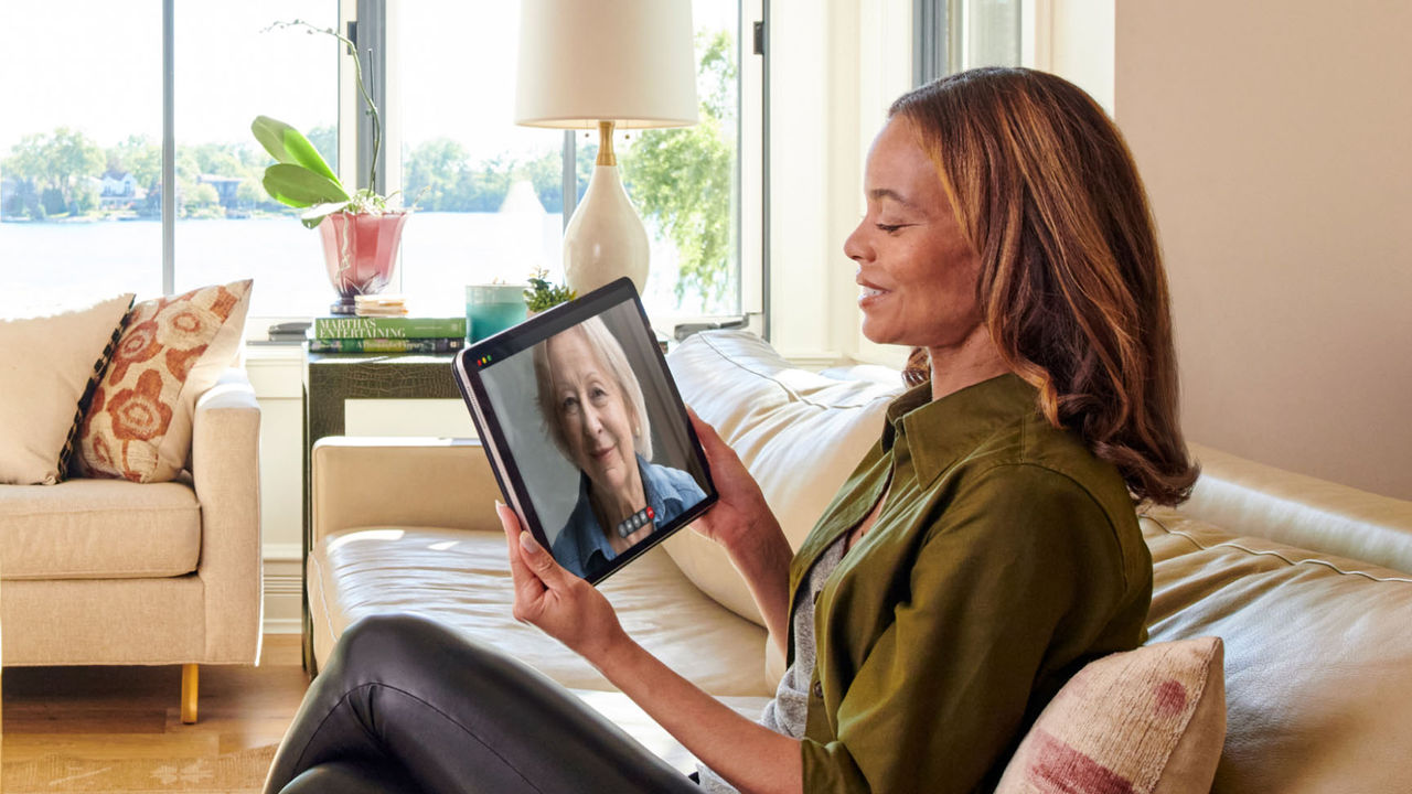 Courtney video chatting with a woman on a tablet