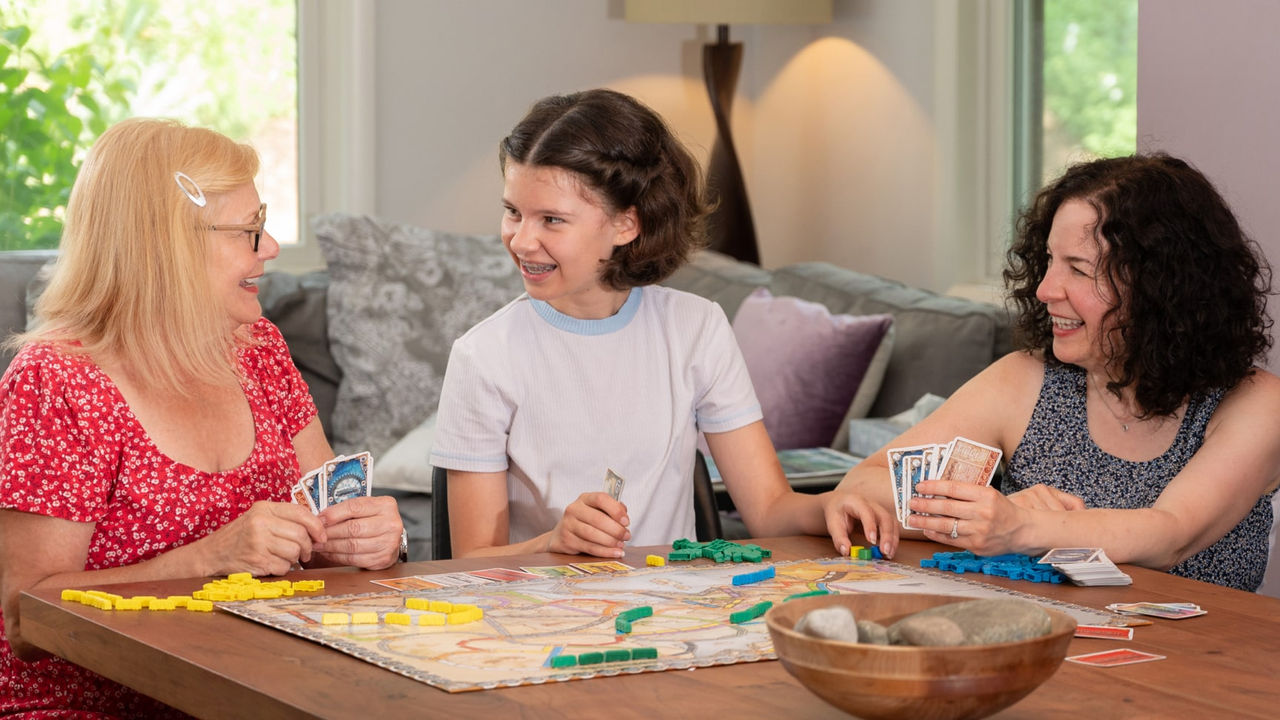 Kathy and Diane playing a game with their daughter
