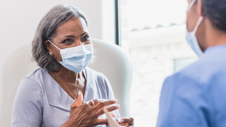 Doctor and patient talking with masks on